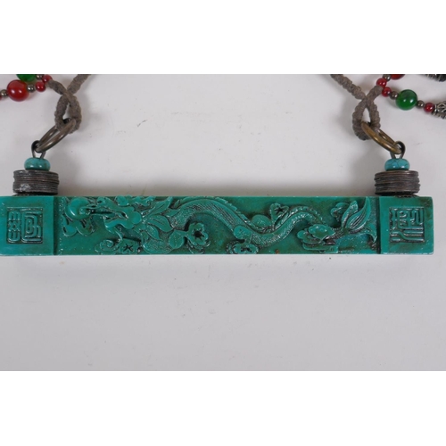 206 - A Chinese turquoise glass scroll weight hanger decorated with a dragon chasing the flaming pearl, 23... 