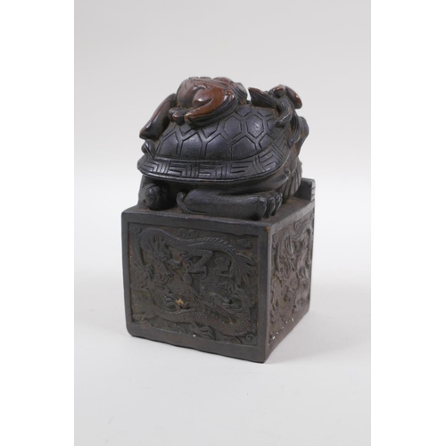 210 - A Chinese filled bronze seal with a Longgui and kylin knop, 8cm x 8cm, 13cm high