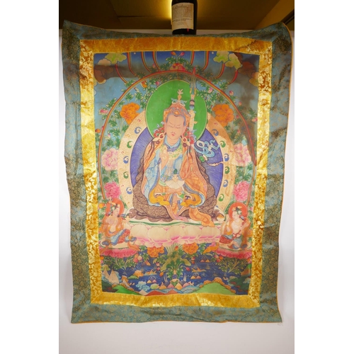 214 - A Tibetan printed thangka within a silk surround, 78 x 110cm