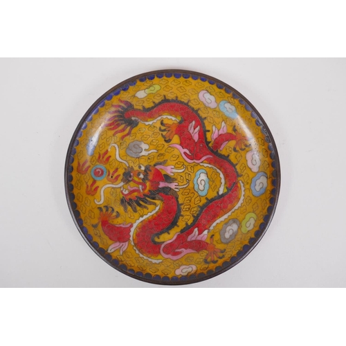 216 - A Chinese yellow ground cloisonne dish decorated with a dragon chasing the flaming pearl, 20cm diame... 