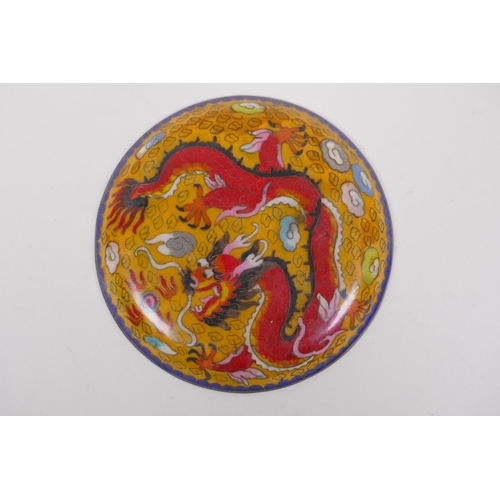 216 - A Chinese yellow ground cloisonne dish decorated with a dragon chasing the flaming pearl, 20cm diame... 