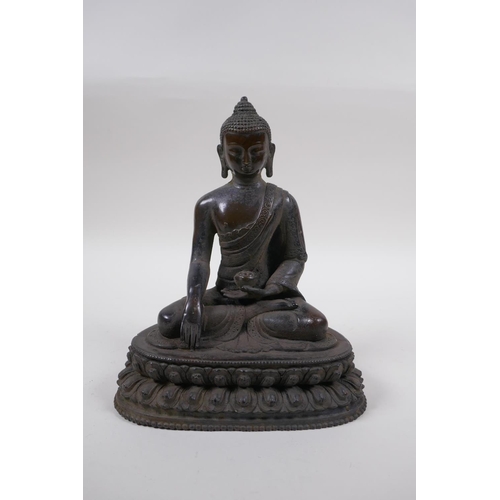 218 - A Sino Tibetan bronze figure of Buddha seated in meditation, 21cm high