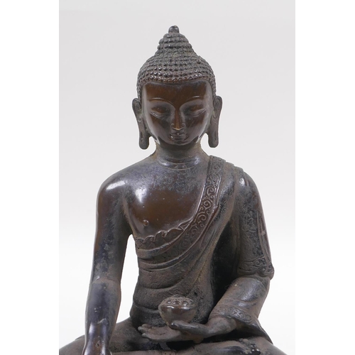 218 - A Sino Tibetan bronze figure of Buddha seated in meditation, 21cm high