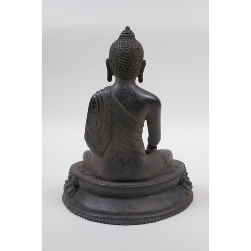 218 - A Sino Tibetan bronze figure of Buddha seated in meditation, 21cm high