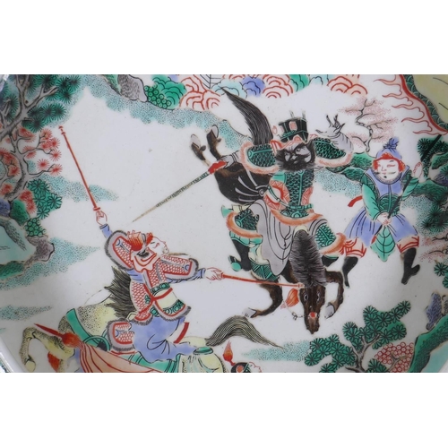 225 - A famille vert porcelain charger with rolled rim, decorated with warriors on horseback, Chinese Kang... 