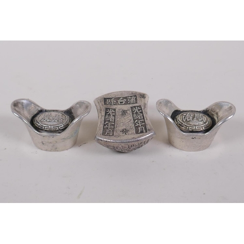 226 - A pair of Chinese white metal tokens/ingots and another similar with impressed character marks, larg... 