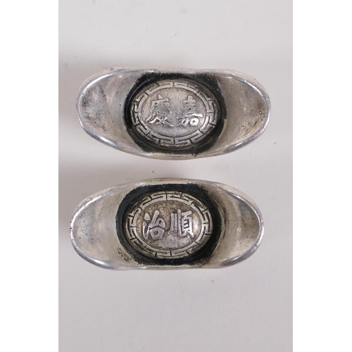 226 - A pair of Chinese white metal tokens/ingots and another similar with impressed character marks, larg... 