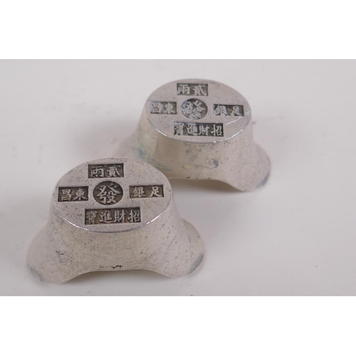 226 - A pair of Chinese white metal tokens/ingots and another similar with impressed character marks, larg... 