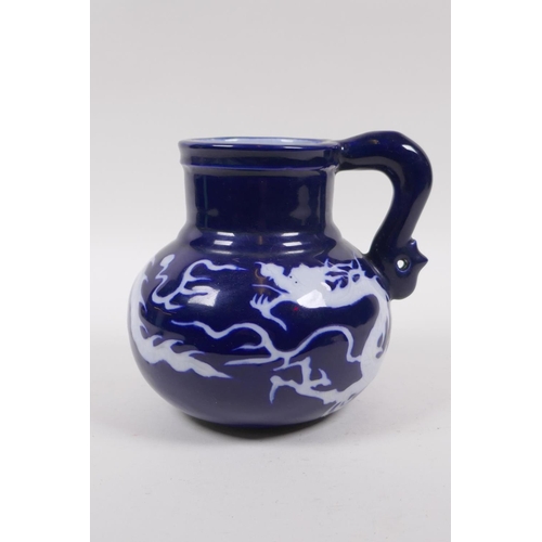 230 - A Chinese blue ground porcelain wine jug with white underglaze dragon decoration, 15cm high