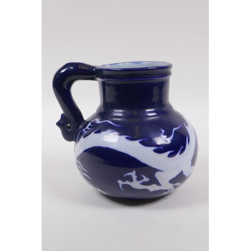 230 - A Chinese blue ground porcelain wine jug with white underglaze dragon decoration, 15cm high