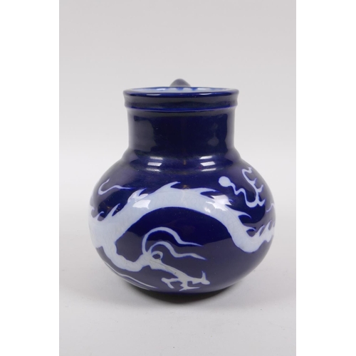 230 - A Chinese blue ground porcelain wine jug with white underglaze dragon decoration, 15cm high