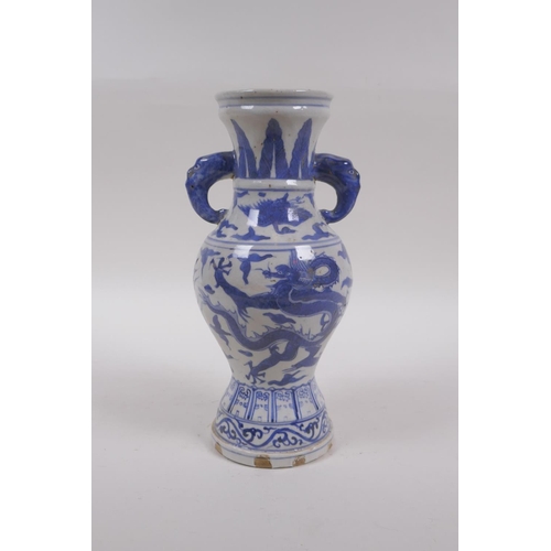 233 - A Chinese blue and white porcelain vase with two elephant mask handles and dragon decoration, 23cm h... 