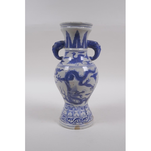 233 - A Chinese blue and white porcelain vase with two elephant mask handles and dragon decoration, 23cm h... 