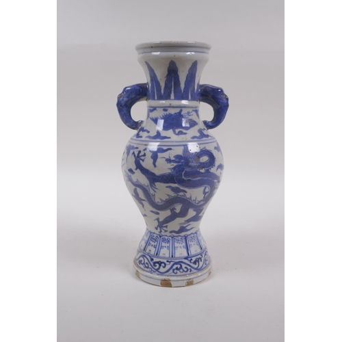 233 - A Chinese blue and white porcelain vase with two elephant mask handles and dragon decoration, 23cm h... 