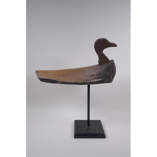 234 - A vintage style decoy duck mounted on a display stand, 47cm high, 37cm long