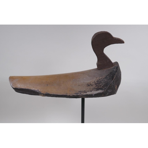 234 - A vintage style decoy duck mounted on a display stand, 47cm high, 37cm long