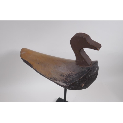 234 - A vintage style decoy duck mounted on a display stand, 47cm high, 37cm long