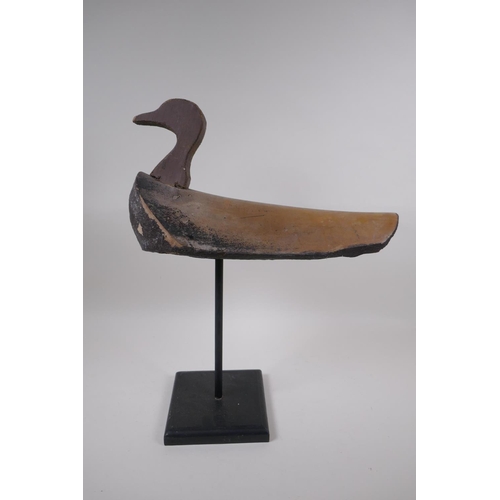 234 - A vintage style decoy duck mounted on a display stand, 47cm high, 37cm long