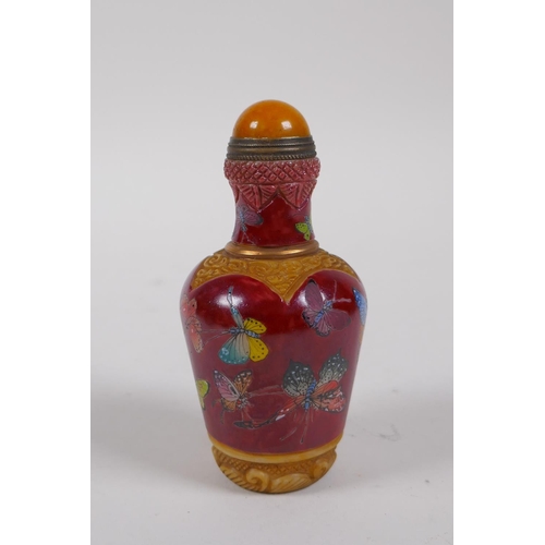 236 - A Chinese moulded glass snuff bottle with enamelled butterfly decoration, 4 character mark to base, ... 