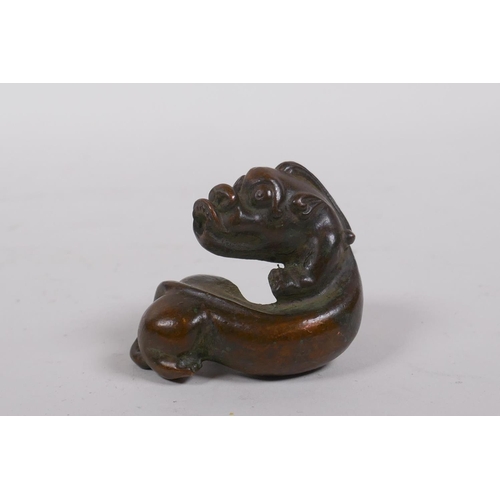 245 - A Japanese style bronze okimono kylin, 5cm long