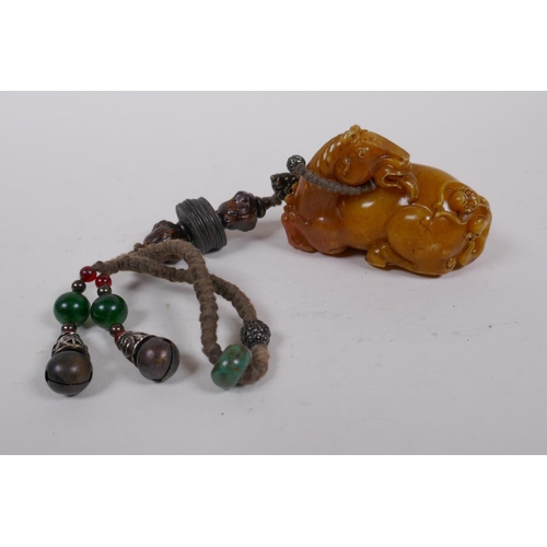 248 - A Chinese reconstituted amber soapstone toggle in the form of a horse, 8cm long