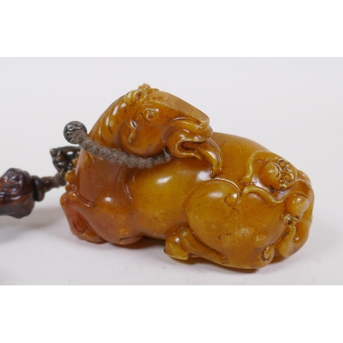 248 - A Chinese reconstituted amber soapstone toggle in the form of a horse, 8cm long