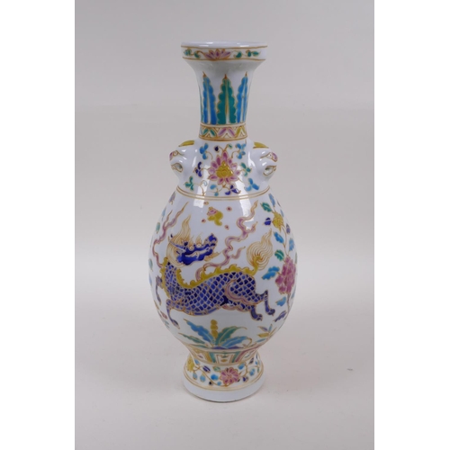 250 - A Chinese polychrome porcelain vase with two mask handles decorated with lotus flowers and mythical ... 