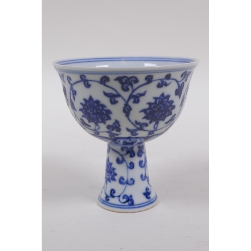 253 - A blue and white porcelain stem bowl with scrolling lotus flower decoration, Chinese Xuande 6 charac... 