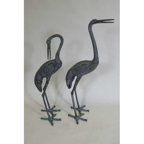 254 - A pair of decorative metal garden cranes, largest 81cm high