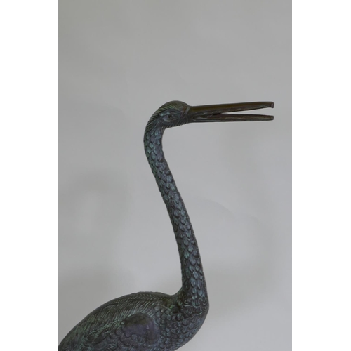 254 - A pair of decorative metal garden cranes, largest 81cm high