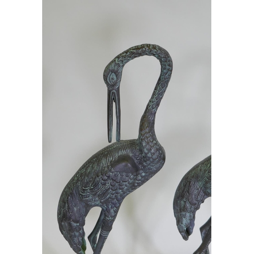 254 - A pair of decorative metal garden cranes, largest 81cm high