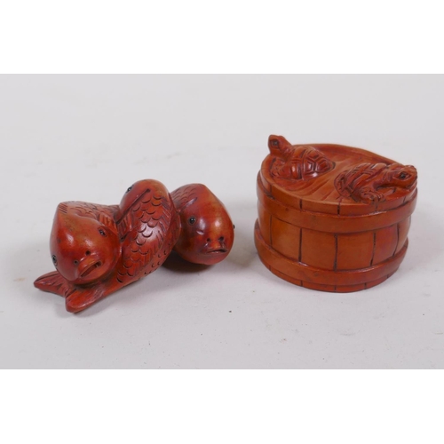 255 - A Japanese carved boxwood netsuke in the form of three carp, and another in the form of a barrel wit... 