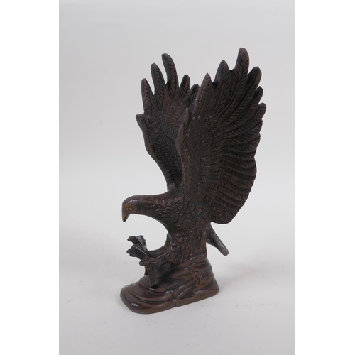 256 - A cast bronzed metal eagle, 19cm high