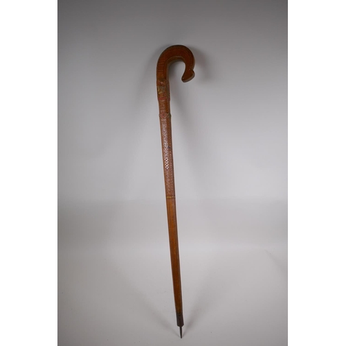 257 - An East European walking stick with carved and stained Christian iconography decoration, 90cm long