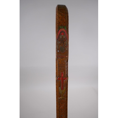 257 - An East European walking stick with carved and stained Christian iconography decoration, 90cm long