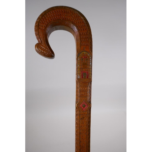 257 - An East European walking stick with carved and stained Christian iconography decoration, 90cm long