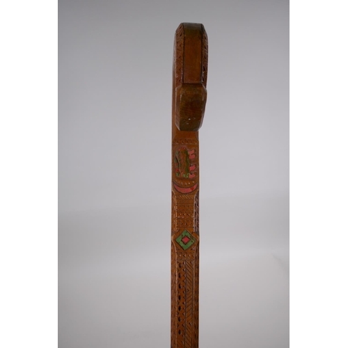 257 - An East European walking stick with carved and stained Christian iconography decoration, 90cm long