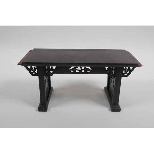 26 - A Chinese carved and pierced hardwood stand in the form of a miniature altar table, 22cm wide