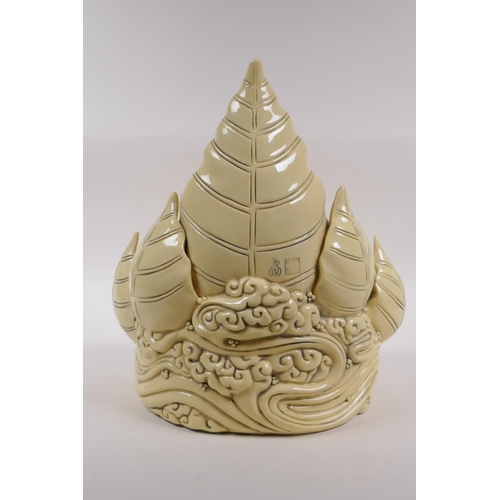 260 - A Chinese blanc de chine porcelain figure of Buddha seated within a blooming lotus flower, impressed... 