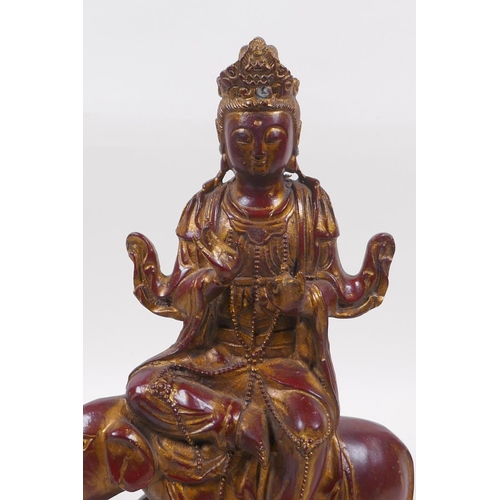 263 - A Chinese coppered bronze of Quan Yin seated upon an elephant with the remnants of gilt patina, 32cm... 