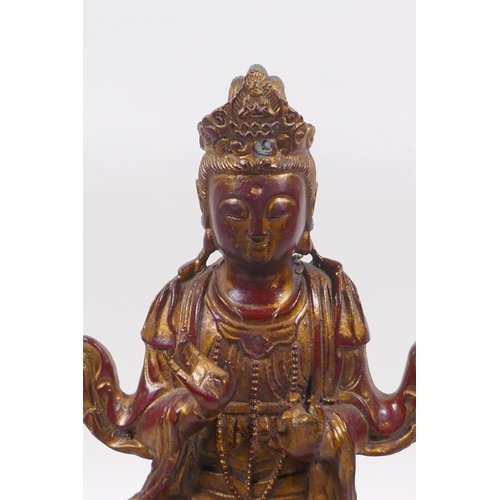 263 - A Chinese coppered bronze of Quan Yin seated upon an elephant with the remnants of gilt patina, 32cm... 