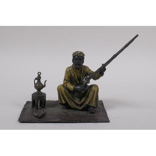 273 - After Bergman, a cold painted bronze figure of a seated Arab with a rifle, 13 x 9cm