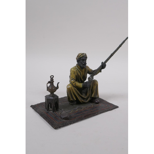 273 - After Bergman, a cold painted bronze figure of a seated Arab with a rifle, 13 x 9cm