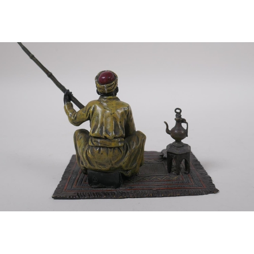 273 - After Bergman, a cold painted bronze figure of a seated Arab with a rifle, 13 x 9cm