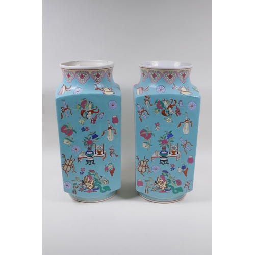 28 - A pair of blue ground square form porcelain vases with famille rose decorative panels depicting trav... 