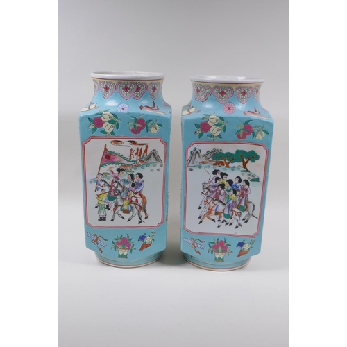 28 - A pair of blue ground square form porcelain vases with famille rose decorative panels depicting trav... 