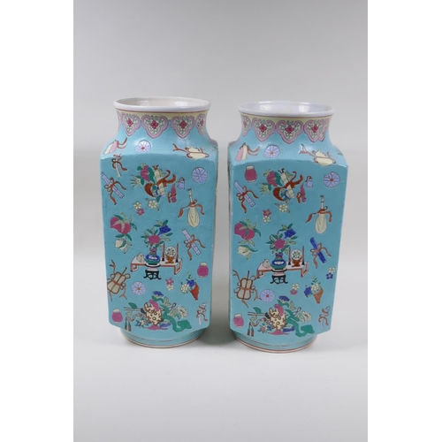 28 - A pair of blue ground square form porcelain vases with famille rose decorative panels depicting trav... 