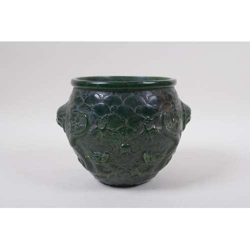 284 - A Chinese reconstituted green hardstone jar with two lion mask handles and raised dragon decoration