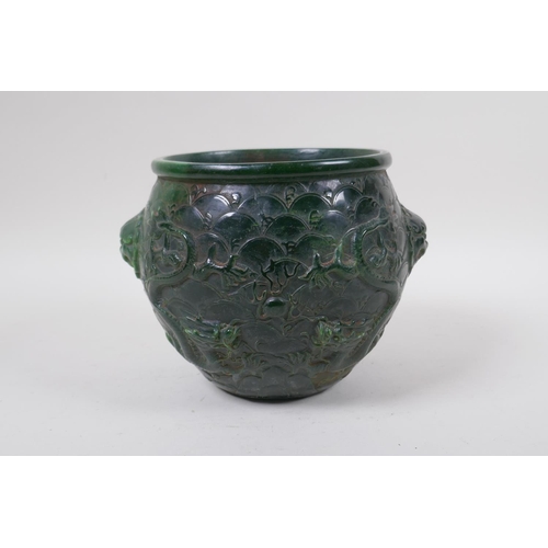 284 - A Chinese reconstituted green hardstone jar with two lion mask handles and raised dragon decoration