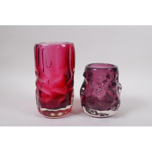 298 - An amethyst studio glass vase and a similar cranberry studio glass vase, largest 7½